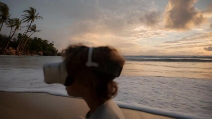 Young individual experiences virtual reality with VR headset on sandy ocean beach during colorful sunset with clouds and horizon. - Powered by Adobe