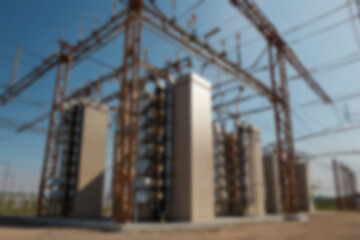 blurry electrical substation, large transformer as voltage regulator, there are many high voltage electrical panels