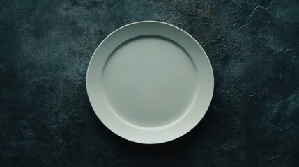 Empty white plate on dark textured surface. (1)