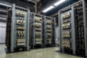 blurry electrical substation, large transformer as voltage regulator, there are many high voltage electrical panels