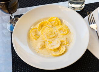 Delicious italian ravioli with cheese served in sauce on platter