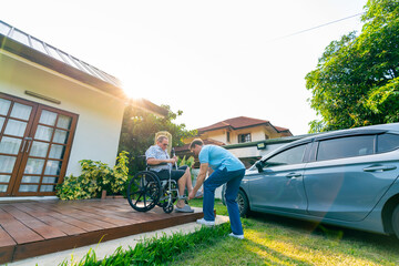 Male caregiver or taxi driver helping senior man patient on wheelchair get in the car go to hospital for medical appointments or healthcare therapy. Assisted elderly patient transportation services. © CandyRetriever 