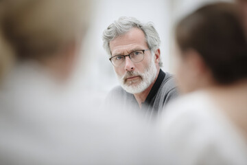 diverse group of professionals engaged in collaborative discussion showcasing trust and openness