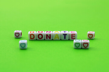 Cubes with the word donate next to several hearts