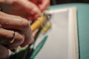 an elderly woman making a flower
