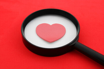 Magnifying glass searches and finds a big red heart