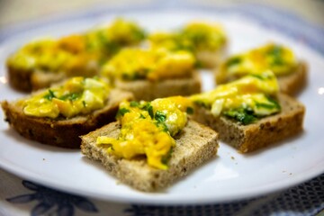 Scrambled eggs with parsley served on sourdough artisan bread