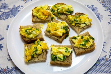 Scrambled eggs with parsley served on sourdough artisan bread