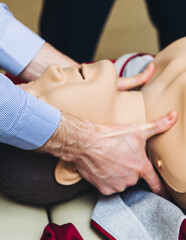 First aid training course with dummy, CPR emergency reanimation procedure on mannequin, instructor...