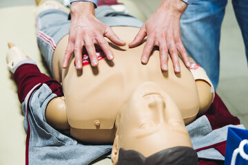 First aid training course with dummy, CPR emergency reanimation procedure on mannequin, instructor...