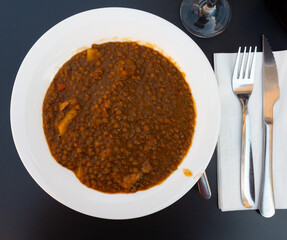 Boiled lentils with meat broth are served in plate. Thick and hearty soup is served in cafes and pubs as warming dish, snack for beer.