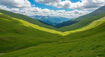Obraz premium Lush green valley representing natural beauty and serenity with mountain range and cloudy sky