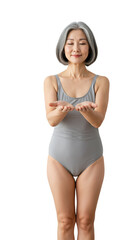 Fototapeta premium A graceful elderly Asian woman in a grey swimsuit stands with outstretched hands, expression serene, against a transparent background, symbolizing peace and tranquility.