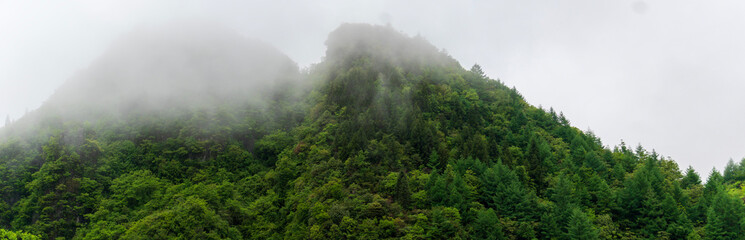 mountains and valleys where fog and clouds rise.