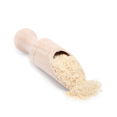Superfood product. Sesame seeds powder in scoop isolated on white