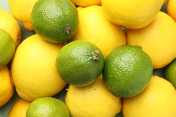 Fresh ripe lemons and limes as background, closeup