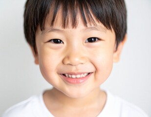 Naklejka premium Close-up of a smiling young Japanese boy with a clean and bright background