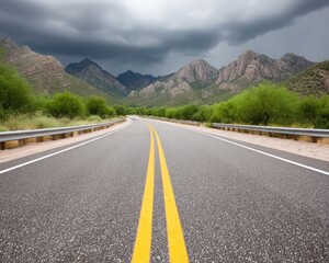 Naklejka premium Scenic Road Winding Through Mountains Under Dark Clouds