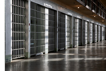 A long hallway with many bars on the windows