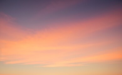 Fototapeta premium Sky with soft pastel colors ranging from orange to purple at sunset.