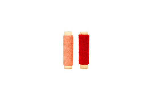 Red spool and Pink spool of sewing thread isolated on white background 