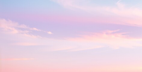 Obraz premium Soft pastel sky with pink purple and blue clouds at sunrise or sunset.