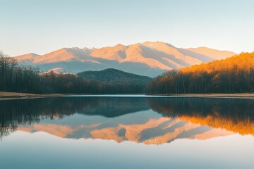 Fototapeta premium A breathtaking view of a serene mountain landscape at sunrise, with golden light illuminating the peaks and a calm lake reflecting the scenery. Perfect for use in travel marketing, nature blogs