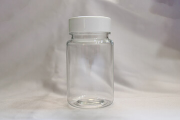 An empty bottle. an empty capsule bottle. an empty medicine bottle.