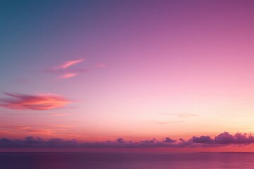 Calm ocean under a vibrant pink and purple sunset sky with soft clouds along the horizon