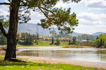 View from the Love Stone over the Biya River with the town of Turochak on the opposite bank. Concept of serenity, connection, and sacred places in wild Russian nature