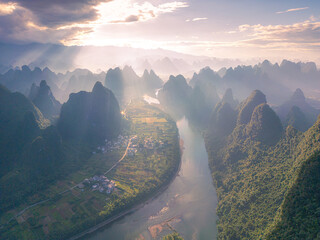 Drone shot of the first rays of light through the clouds in Xianggong hill, Guangxi, China