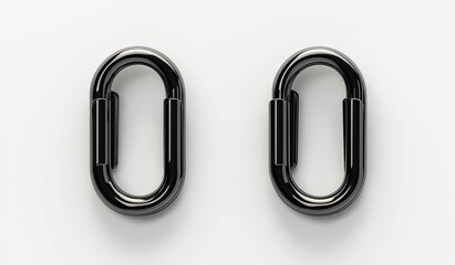 Obraz premium Two polished black oval-shaped metal links, positioned horizontally, against a white background. They appear to be connector components, designed for attaching or joining other pieces
