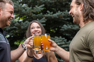 Friends celebrating and cheering with beer pints for National Beer Lover's Day.