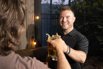 Friends celebrating and cheering with beer pints for National Beer Lover's Day.
