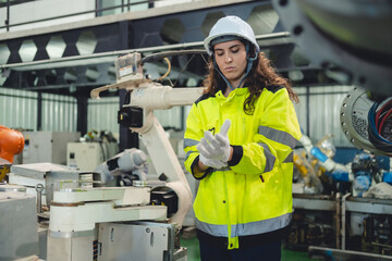 Engineer Technician Working with Robotic Arm in Futuristic Factory: Automation Technology for...