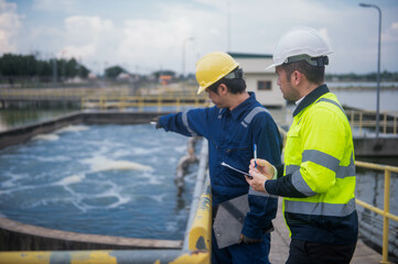 An inspector and a water treatment plant engineer are working together to plan a change in the treatment plant's water filter to bring the water up to state standards.