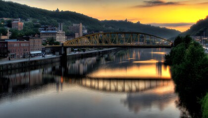 Scenic river valley at golden hour with bridge reflection.