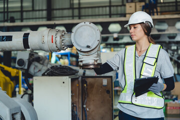 Technician Engineer Operating Robotic Arm in Factory, Automation and Advanced Technology to Enhance Production Control in Manufacturing Industry, Driving Innovation and Efficient Machine Work