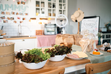 Cozy kitchen workshop filled with handmade bakery goods, fresh ingredients, takeaway packaging, vibrant decorations creating for home baking, cooking classes small business inspiration