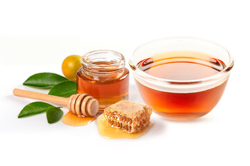 Glass bowl of honey with honey comb and honey stick , leaves isolated on white background.