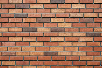 Obraz premium Close up shot of a brick wall with varying shades of red and brown bricks