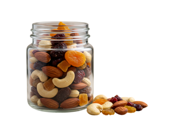 Assortment of delicious mixed nuts and dried fruits in a glass jar against a black background