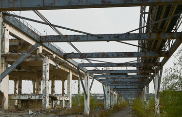 Naklejka premium abandoned factory concrete steel framework industrial ruins
