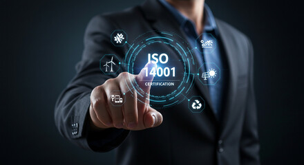 A man in a suit pointing at a holographic display of iso certification icons on a dark background real estate business ,technology ,selling ,purchasing ,agreement ,$