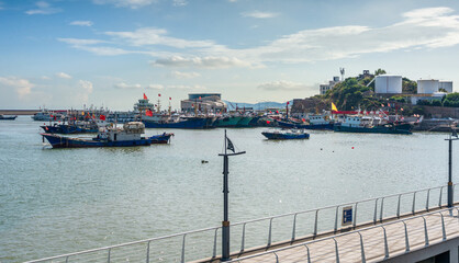 Tranquil Harbor Scene with Fishing Boats and Serene Water Reflection