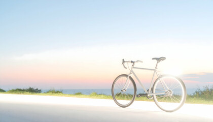 Silver Bicycle Parked on Road Against Scenic Ocean Sunset Blue and Orange Sky Warm Light
