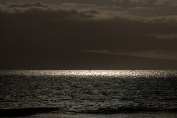 Dramatic Ocean View Under a Cloudy Sky with Light Reflections