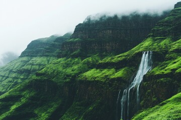 Lush mountain waterfall cascading down verdant cliffs