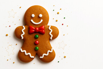 Classic Gingerbread Man Cookie with Red Bow Tie and Colorful Buttons on White Background with Star Shapes and Crumbs – Festive Holiday Treat in Horizontal 16:9 Format