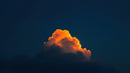 A glowing sunlit cloud formation against a deep blue sky